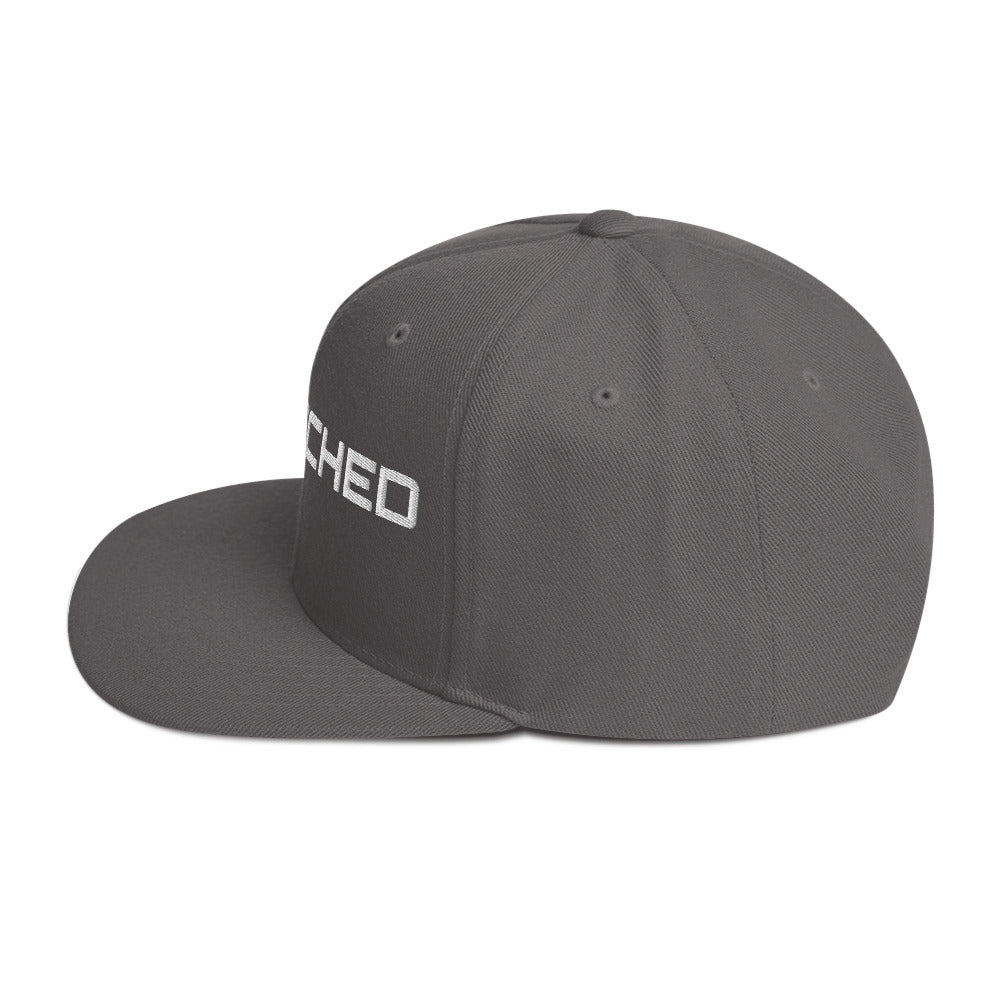 SecNews Patched Embroidered Snapback in Dark Grey, left side view, with embroidered green "PATCHED" checkbox design